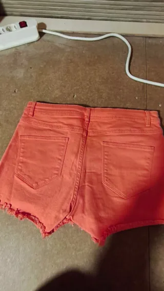 Vaqueros cortos coral con flecos
