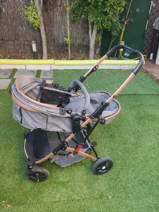 Carrito de bebé gris y cobre