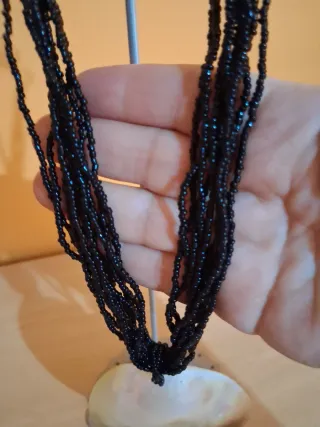 Collar artesanal con colgante de concha nacarada.