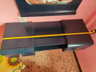 Mueble tocador azul oscuro con espejo.