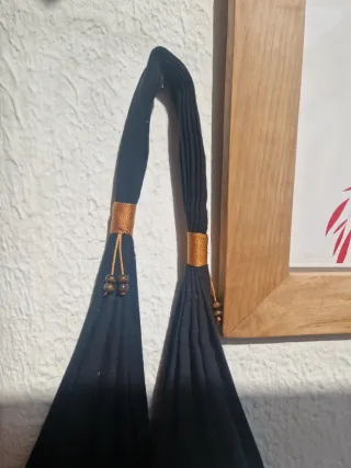 Bolso negro con estampado étnico multicolor.