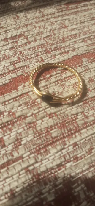 Anillo dorado con piedra negra