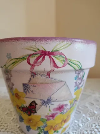 Vaso decorato con ghirlanda, fiori e farfalla
