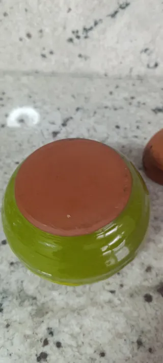 Tarro de barro verde y marrón.