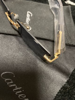 Gafas de sol Cartier negras y doradas