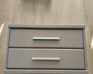 Mesita de noche beige con tiradores plateados
