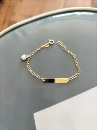 Pulsera bebé oro con corazón nueva.