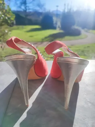 Zapatos de tacón rojos con tachuelas doradas
