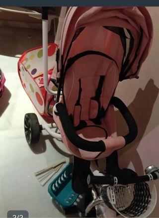 Bicicleta infantil rosa con barra de empuje