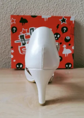 Sandalias de tacón blancas.