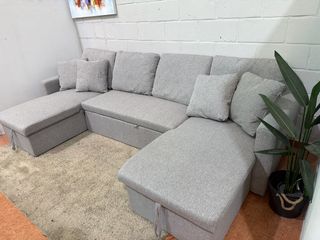 Sofá cama modular gris con arcón