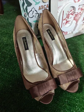 Zapatos de tacón dorados con lazo