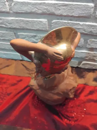 Figura de mujer con sombrero dorado