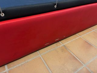 Cama 90x190 en polipiel rojo.