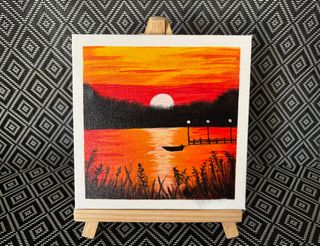 Pintura atardecer con caballete