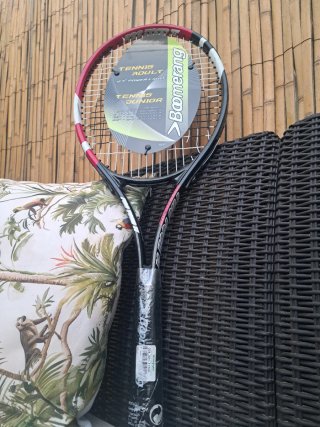 Raqueta de tenis Boomerang con una cuerda rota.