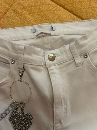 Jeans bianchi con ciondoli a cuore argento