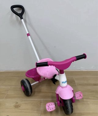 Triciclo infantil rosa con manillar