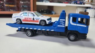 Camión grúa azul con coche de juguete