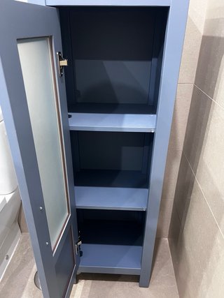 Mueble de baño azul con puerta de cristal