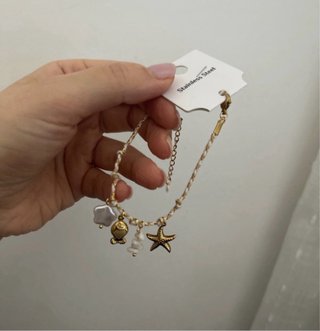 Set collana e bracciale oro e bianche con ciondoli