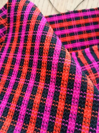 Tela a cuadros y rayas fucsia y naranja y negra