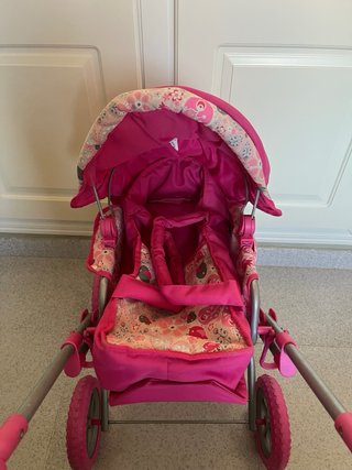 Cochecito de juguete rosa