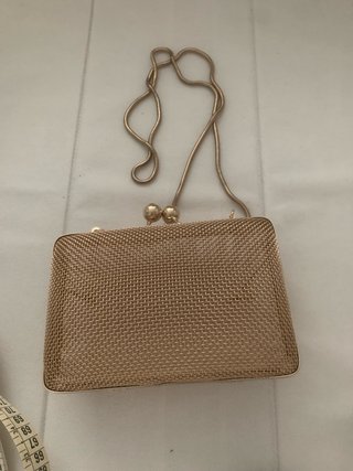 Bolso de mano dorado con cadena