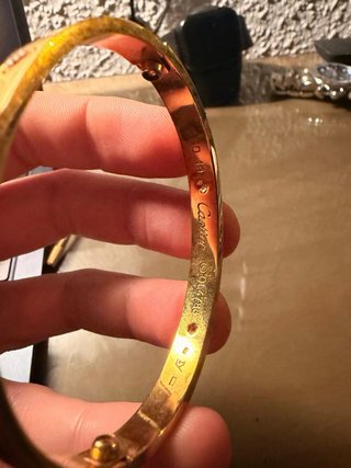 Pulsera dorada con tornillos y piedras