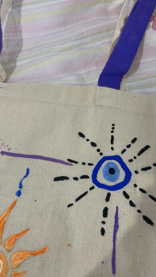 Bolso de tela beige con asas moradas