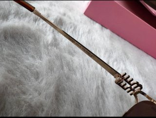 Gafas Miu Miu doradas y marrones