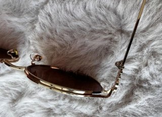 Gafas Miu Miu doradas y marrones