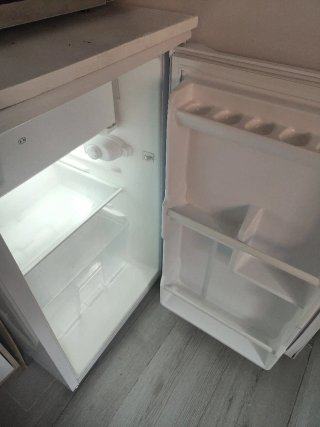 Nevera bajo encimera blanca.