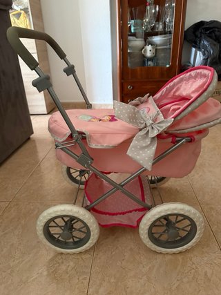 Carrito de muñecas rosa con lazo