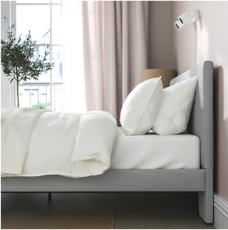Cama con cabecero tapizado gris