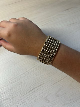 Pulsera metálica dorada trenzada