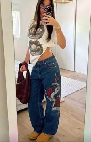 Jeans blu con stampa serpente e rose