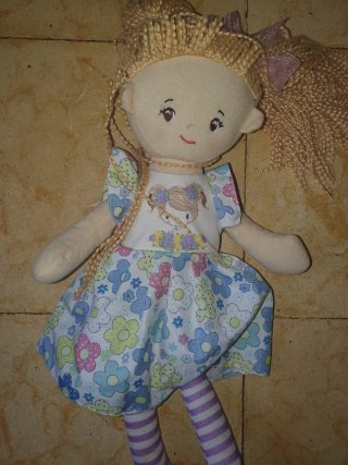 Muñeca de peluche con vestido floral