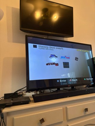 Playstation 2 slim with 2 controllers and 15 games