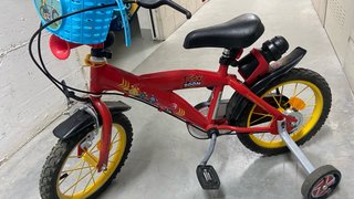 Bicicleta infantil roja con ruedines