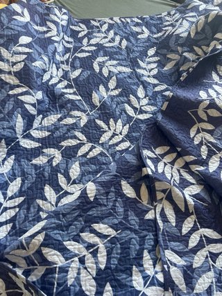 Colcha azul y blanca con hojas