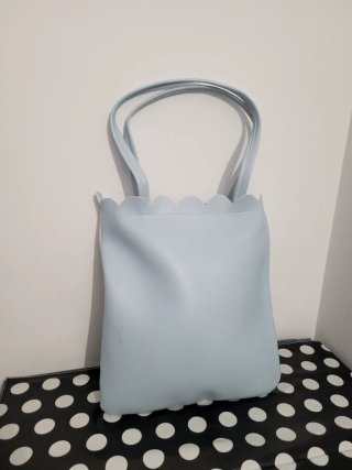 Bolso de mano con estampado floral y musical
