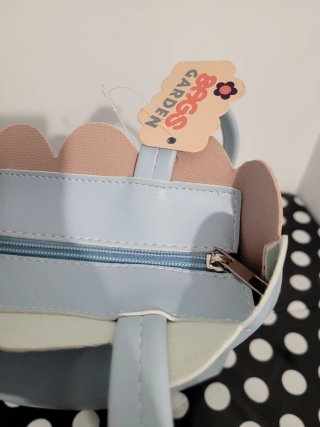 Bolso de mano con estampado floral y musical