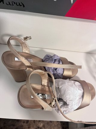Zapatos de tacón beige y dorado.