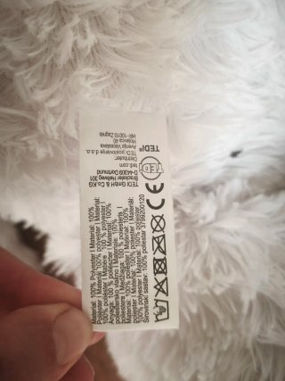 Oso mediano de peluche blanco con lazo