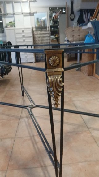 Mesa de hierro forjado con detalles dorados,