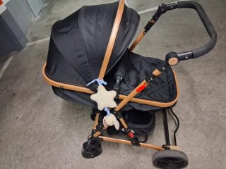 Carro de bebé negro con detalles madera