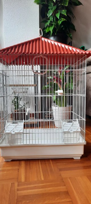 Jaula para pájaros roja y blanca