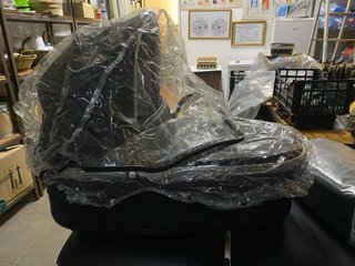 Carro de bebé negro de cuero.