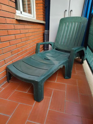 Tumbona plegable de resina con ruedas.